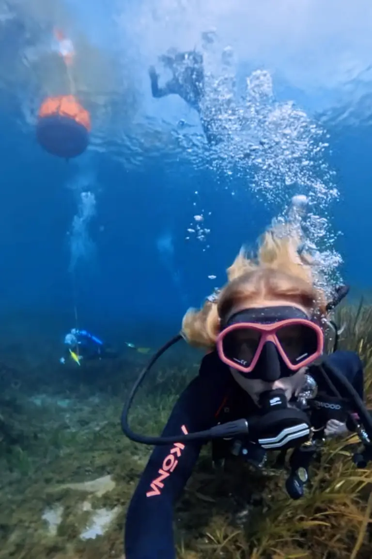 SCUBA diver smiling underwater in Rainbow River.