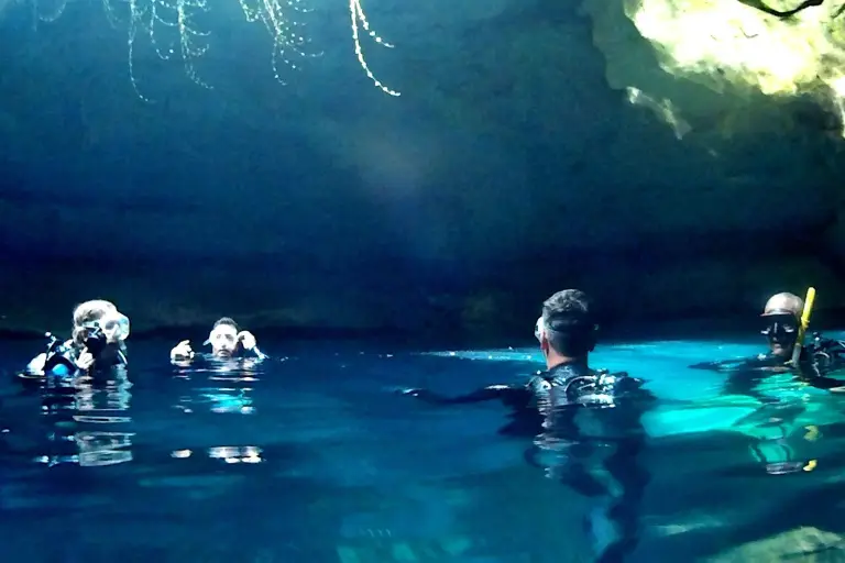 SCUBA students and an instructor practicing together underwater.