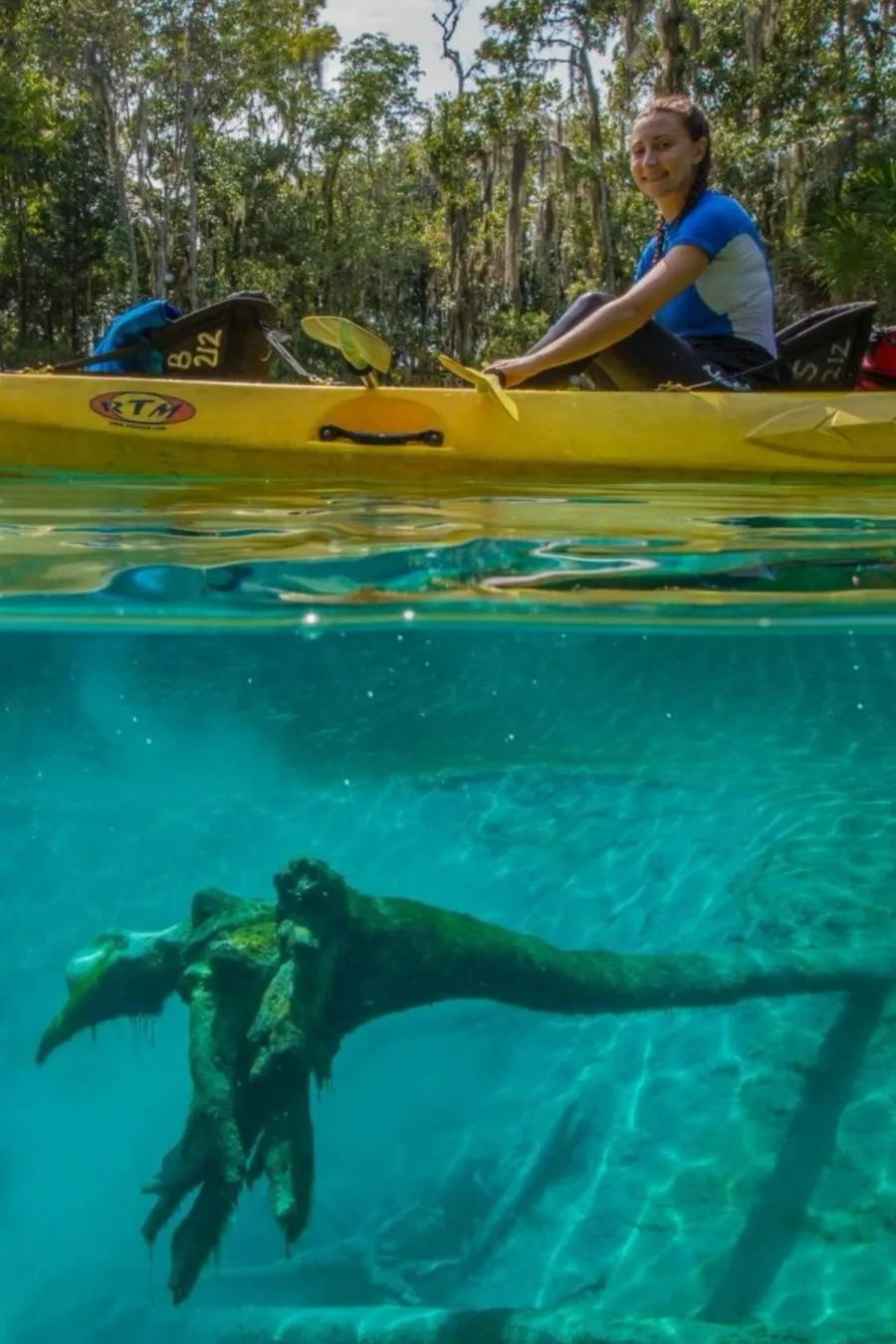 Kayaker paddling above a clear spring at Three Sisters Springs.