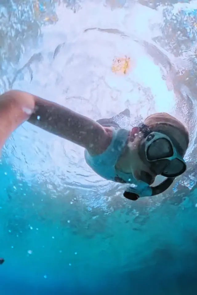 Snorkeler swimming through clear water at Three Sisters Springs.