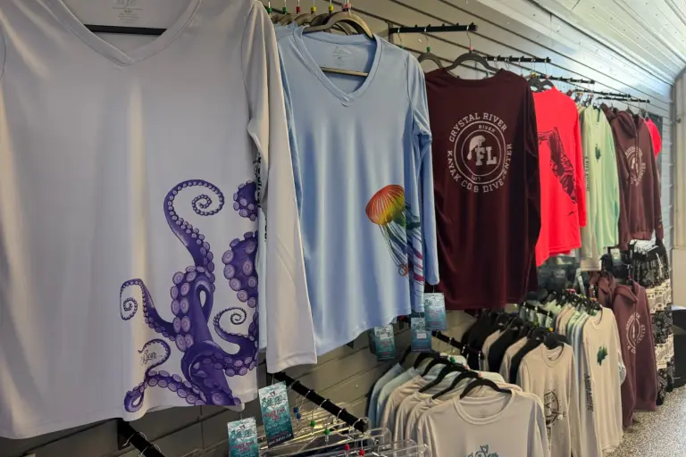 Colorful graphic T-shirts displayed inside the shop.
