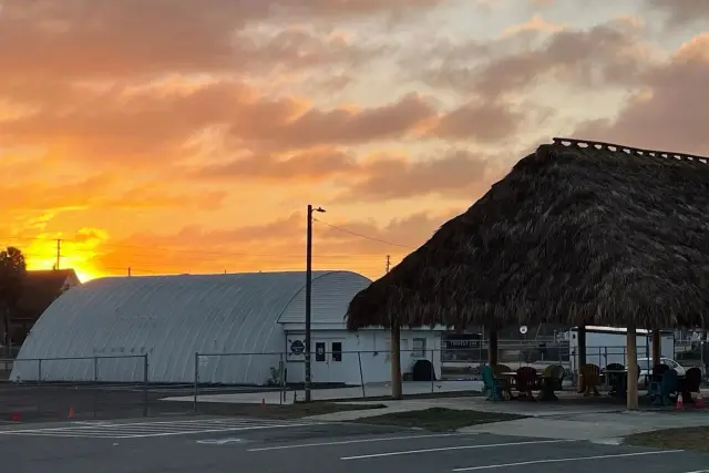 Sunset behind the tiki pavilion at Crystal River Kayak Company & Dive Center.